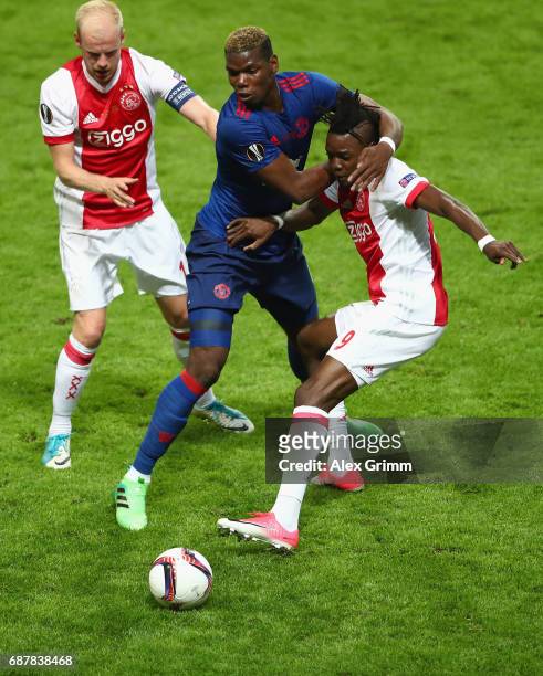 Davy Klaassen of Ajax looks on as Paul Pogba of Manchester United and Bertrand Traore of Ajax battle for possession during the UEFA Europa League...