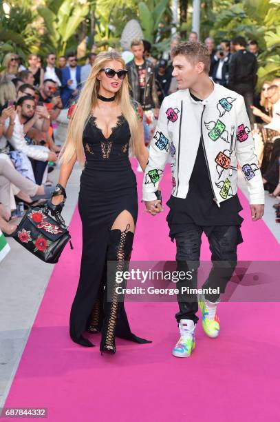 Paris Hilton and Chris Zylka attends the/walks the runway at the Philipp Plein Cruise Show 2018 during the 70th annual Cannes Film Festival at on May...