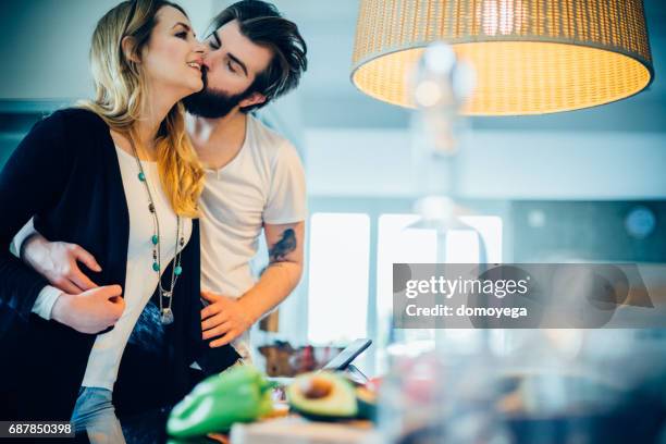 beautiful young couple cooking together healthy meal - low carb diet stock pictures, royalty-free photos & images