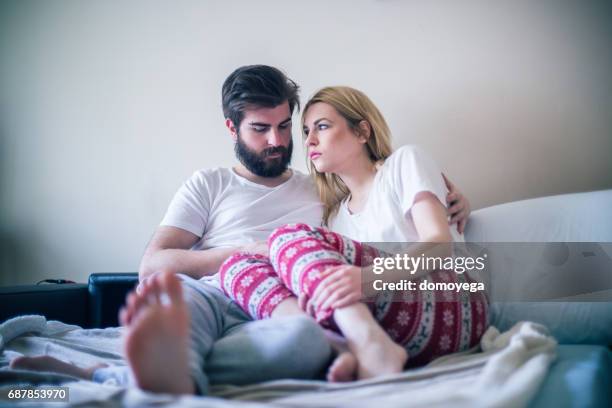 young couple in the bed in the morning - bed conflict stock pictures, royalty-free photos & images