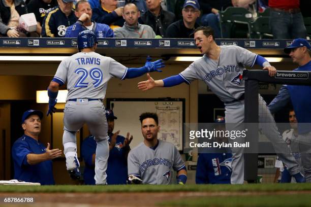 Devon Travis and Chris Coghlan of the Toronto Blue Jays celebrate after Travis hit a home run in the sixth inning against the Milwaukee Brewers at...