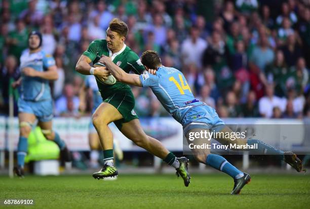 Alex Lewington of London Irish holds off a tackle from Johan Holmes of Yorkshire Carnegie as he runs in to score their fourth try during the Greene...