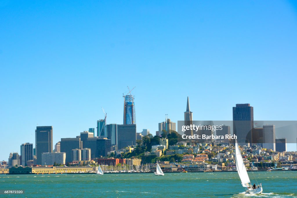 View of San Francisco and the skyline from across the San Francisco Bay with sailboats in the foreground