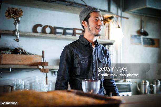 confident young male happy cafe owner - ミッドアダルト stock pictures, royalty-free photos & images