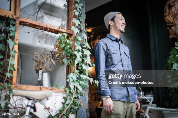 confident young male happy cafe owner - ミッドアダルト stock pictures, royalty-free photos & images