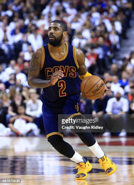 Kyrie Irving of the Cleveland Cavaliers dribbles the ball in the second half of Game Three of the Eastern Conference Semifinals against the Toronto...