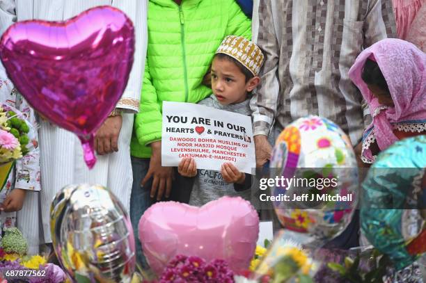 Members of the Muslim community gather at the floral tributes at St AnnÕs Square on May 24, 2017 in Manchester, England.An explosion occurred at...