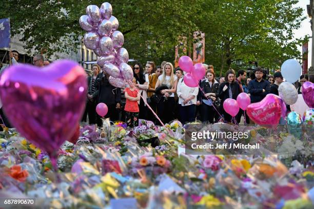 Members of the public pause to look at floral tributes and messages in St Anns Square on May 24, 2017 in Manchester, England. An explosion occurred...
