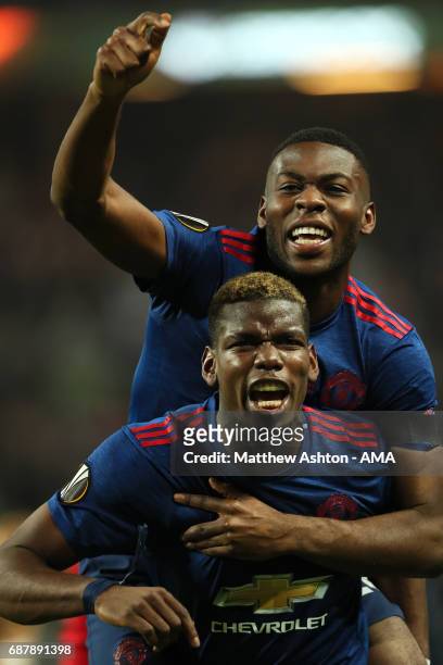 Paul Pogba of Manchester United celebrates with Timothy Fosu-Mensah at the end of the UEFA Europa League Final between Ajax and Manchester United at...