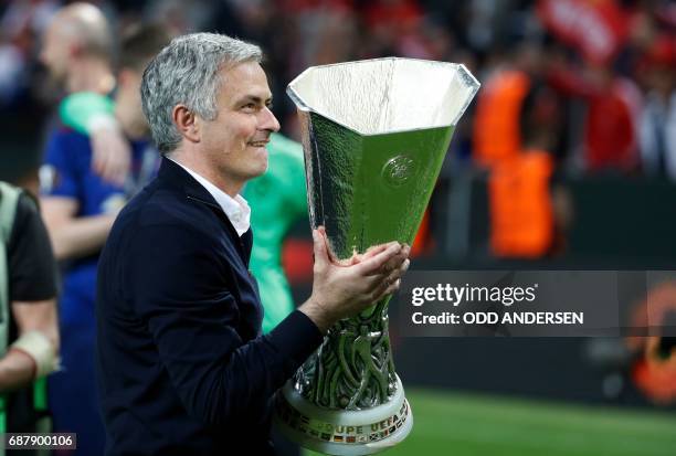 Manchester United's Portuguese manager Jose Mourinho celebrates with the trophy after the UEFA Europa League final football match Ajax Amsterdam v...