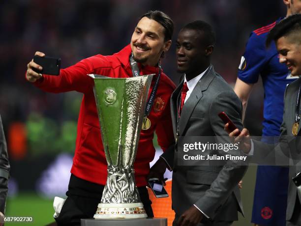 Zlatan Ibrahimovic of Manchester United and Eric Bailly of Manchester United take a selfie photograph with the trophy after the UEFA Europa League...