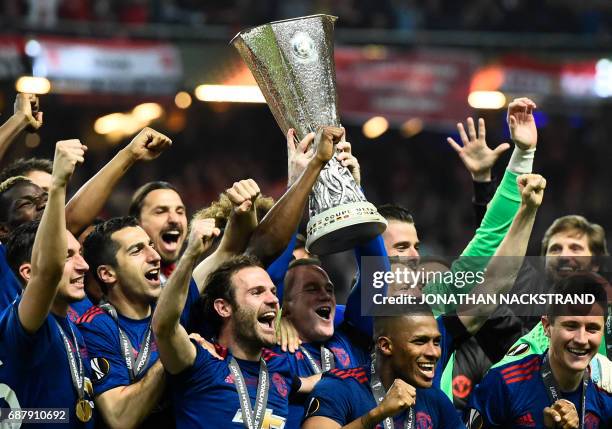 Manchester United's players celebrate with the trophy after winning the UEFA Europa League final football match Ajax Amsterdam v Manchester United on...