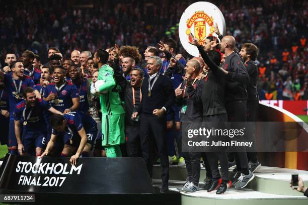 The Manchester United tem and staff celebrate with The Europa League trophy after the UEFA Europa League Final between Ajax and Manchester United at...