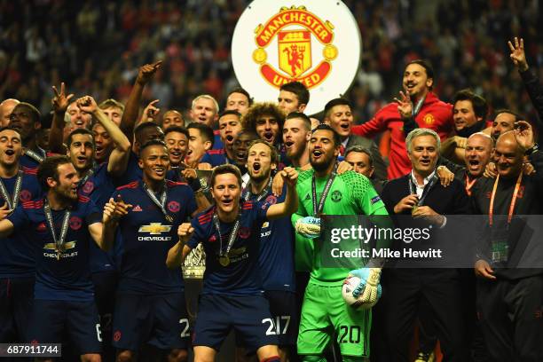 The Manchester United tem and staff celebrate with The Europa League trophy after the UEFA Europa League Final between Ajax and Manchester United at...
