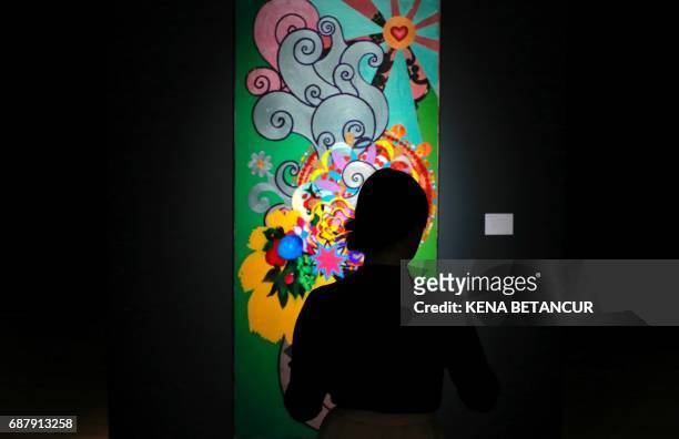 Painting of Artist Beatriz Milhazes is on displayd before a Latin American Art auction at Christies on May 24, 2017 in New York. / AFP PHOTO / Kena...