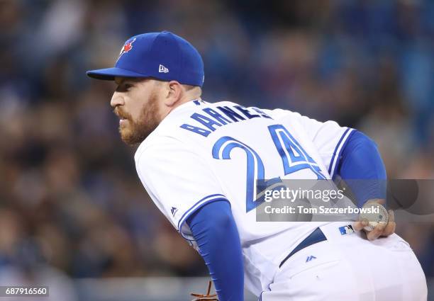 Danny Barnes of the Toronto Blue Jays looks in before delivering a pitch in the fifth inning during MLB game action against the Cleveland Indians at...