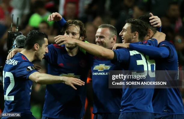 Manchester United's Armenian midfielder Henrikh Mkhitaryan , Manchester United's English striker Wayne Rooney and teammates celebrate after they won...