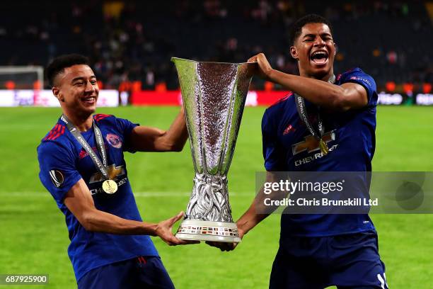 Jesse Lingard and Marcus Rashford of Manchester United celebrate with the trophy following the UEFA Europa League Final match between Ajax and...