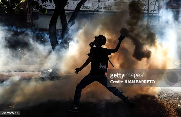 An opposition demonstrator clashes with riot police in Caracas, on May 24, 2017. Venezuela's President Nicolas Maduro formally launched moves to...