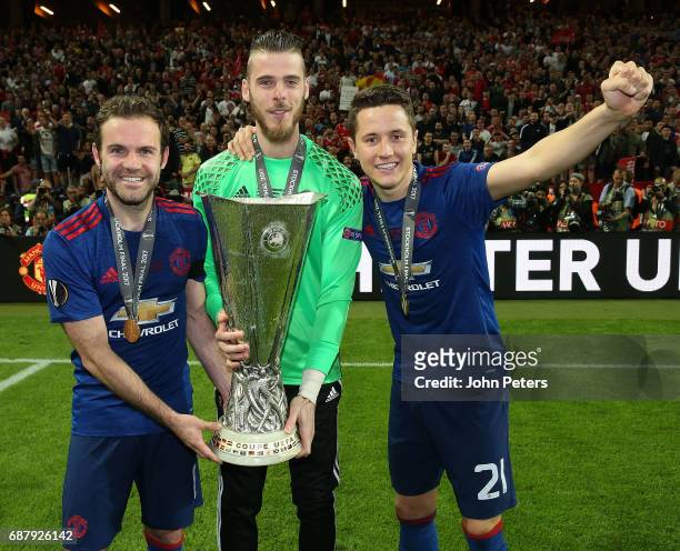 Juan Mata David de Gea and Ander Herrera of Manchester United celebrate with the Europa League trophy after the UEFA Europa League Final match...