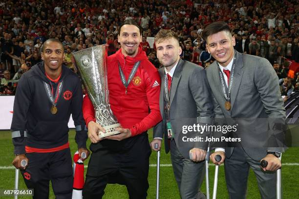 Ashley Young, Zlatan Ibrahimovic, Luke Shaw and Marcos Rojo of Manchester United celebrate with the Europa League trophy after the UEFA Europa League...