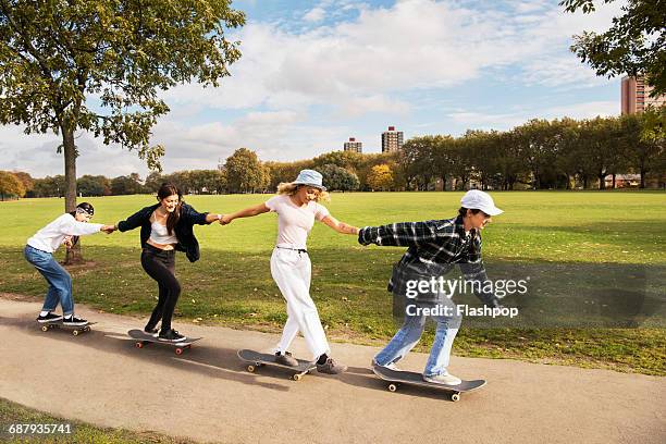 friends skateboarding in a park - skateboard park imagens e fotografias de stock