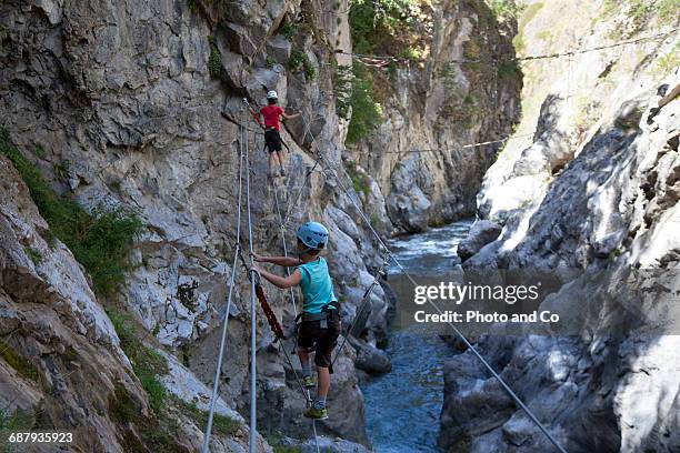 two children on via ferrata, climbing - glen haven co stock pictures, royalty-free photos & images