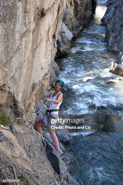 woman on via ferrata, climbing - glen haven co stock pictures, royalty-free photos & images