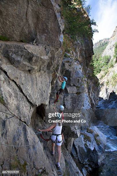 two children and woman on via ferrata, climbing - glen haven co stock pictures, royalty-free photos & images
