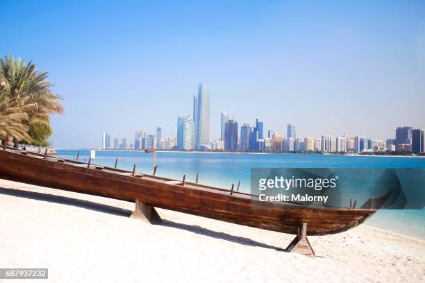 uae, skyline of abu dhabi at the waterfront, beach - abu dhabi city photos et images de collection