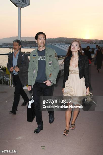 Adrien Brody and Lara Lieto are seen walking by the sea during the 70th annual Cannes Film Festival on May 24, 2017 in Cannes, France.