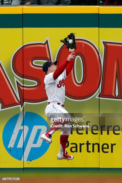 Daniel Robertson of the Cleveland Indians makes a leaping catch to get out Scott Schebler of the Cincinnati Reds during the second inning at...
