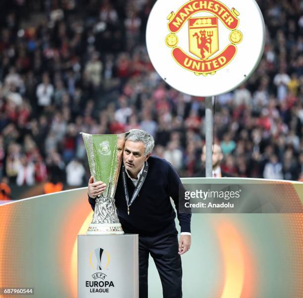 Coach Jose Mourinho of Manchester United is seen near the trophy as he celebrates after the UEFA Europa League Final match between Ajax and...