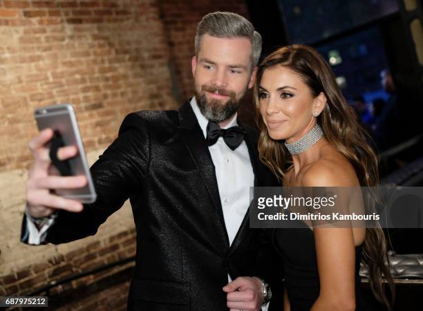 Ryan Serhant and Emilia Bechrakis make selfies during the Million Dollar Listing: New York Season 6 Premiere Party at Marquee on May 24, 2017 in New...