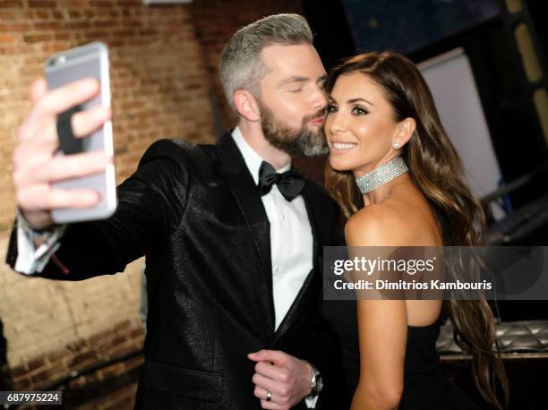 Ryan Serhant and Emilia Bechrakis make selfies during the Million Dollar Listing: New York Season 6 Premiere Party at Marquee on May 24, 2017 in New...