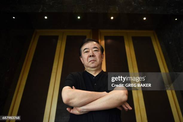 This photo taken on May 21, 2017 shows writer Zhou Meisen at his hotel during a visit to Beijing. - In the midst of China's Cultural Revolution, a...