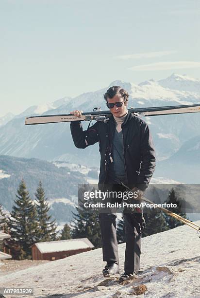Crown Prince Carl Gustaf of Sweden pictured carrying a pair of skis on a winter vacation in Switzerland in January 1971.
