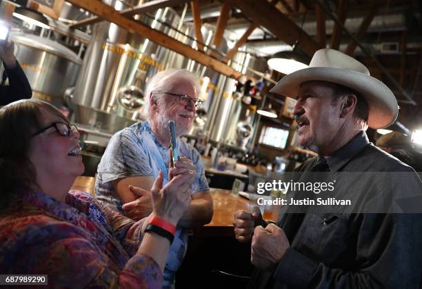 Democratic U.S. Congressional candidate Rob Quist greets supporters during a campaign rally at Draught Works Brewery on May 24, 2017 in Missoula,...