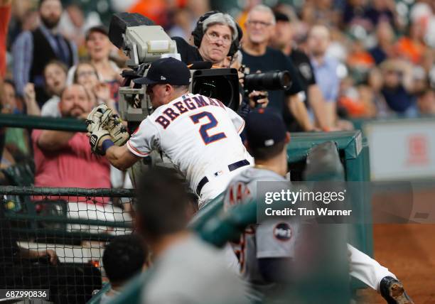 Alex Bregman of the Houston Astros catches a foul ball falling into the dugout in the fifth inning against the Detroit Tigers at Minute Maid Park on...