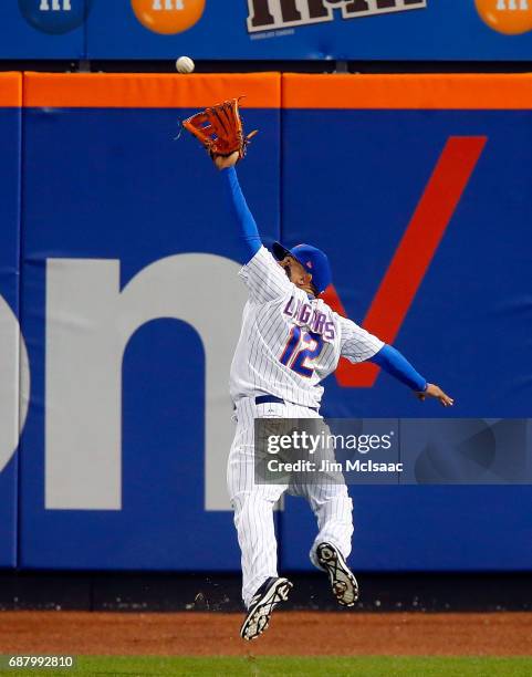 Juan Lagares of the New York Mets makes a running catch for the first out of the eighth inning against the San Diego Padres at Citi Field on May 24,...