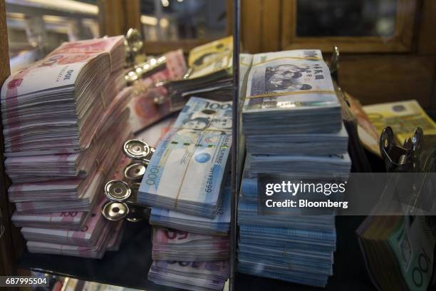 Chinese one hundred yuan banknotes, from left, Philippine one thousand peso banknotes, Chinese one thousand yuan banknotes and Australian one hundred...