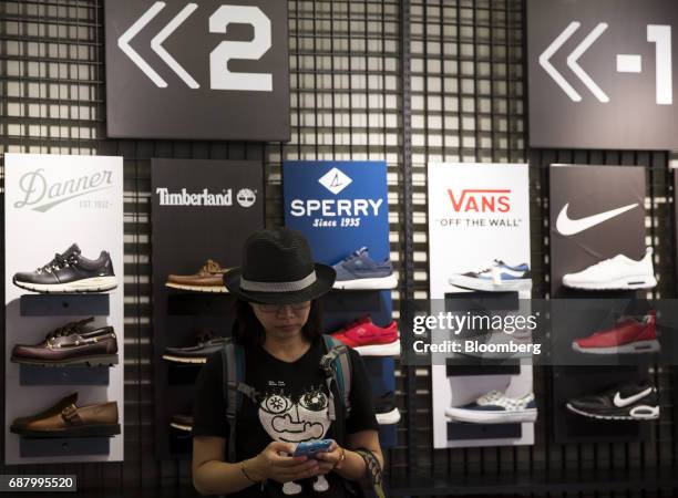 Customer uses a smartphone at a shoe store in the Shibuya area of Tokyo, Japan, on Tuesday, May 23, 2017. Japan is scheduled to release Consumer...