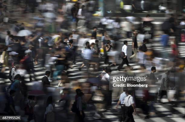 Pedestrians cross a road in the Shibuya area of Tokyo, Japan, on Tuesday, May 23, 2017. Japan's consumer price index for April will be released on...