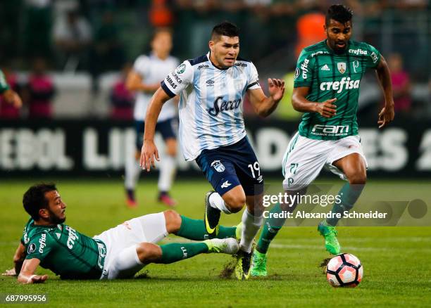 Edu Dracena and Thiago Santos of Palmeiras of Brazil and David Barbona of Atletico Tucuman and in action during the match between Palmeiras and...