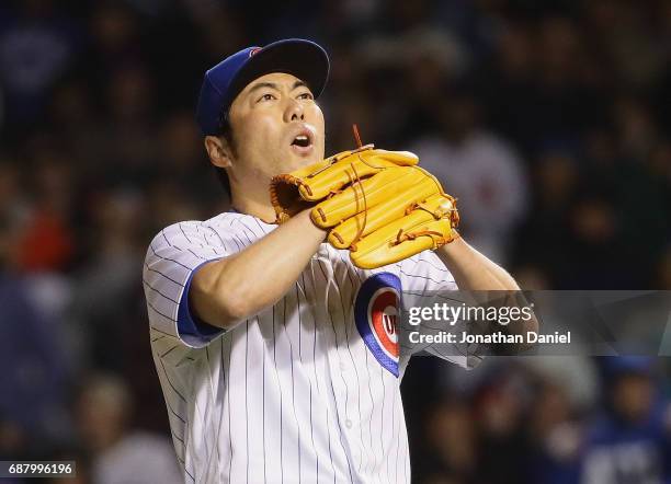 Koji Uehara of the Chicago Cubs reacts after walking the bases loaded in the 8th inning against the San Francisco Giants at Wrigley Field on May 24,...