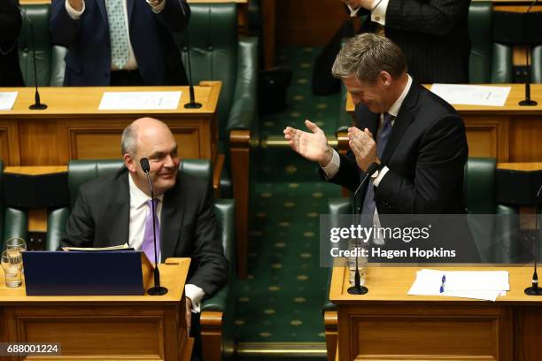 Finance Minister Steven Joyce is applauded by Prime Minister Bill English during the 2017 budget presentation at Parliament on May 25, 2017 in...