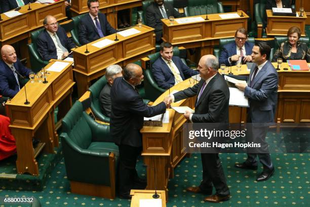 Finance Minister Steven Joyce delivers papers to Maori Party co-leader Te Ururoa Flavell during the 2017 budget presentation at Parliament on May 25,...