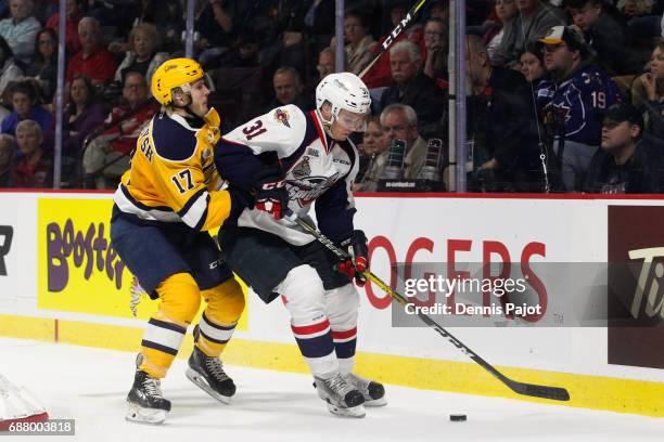 Defenceman Mikhail Sergachev of the Windsor Spitfires moves the puck against forward Taylor Raddysh of the Erie Otters on May 24, 2017 during Game 6...