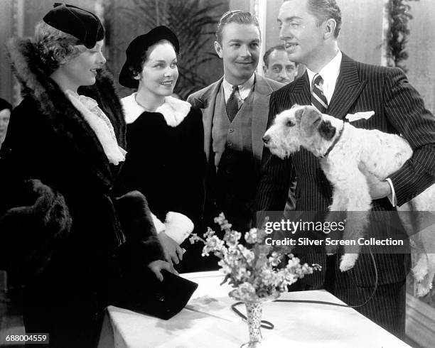From left to right, actors Myrna Loy, Maureen O'Sullivan, Henry Wadsworth, William Powell and Asta the dog in a scene from the film 'The Thin Man',...