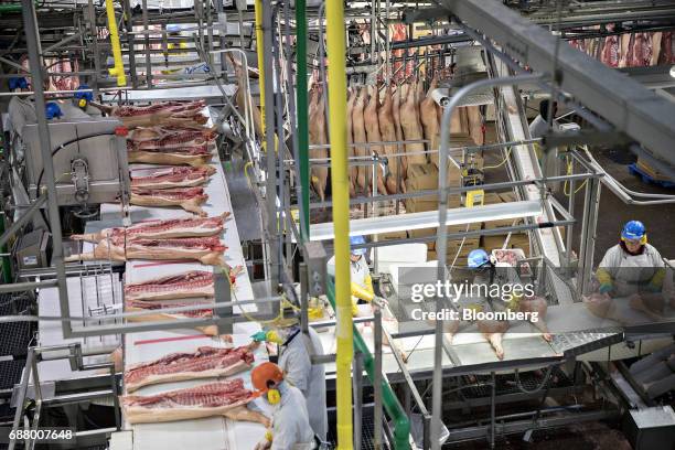 Employees butcher pork at a Smithfield Foods Inc. Pork processing facility in Milan, Missouri, U.S., on Wednesday, April 12, 2017. WH Group Ltd....